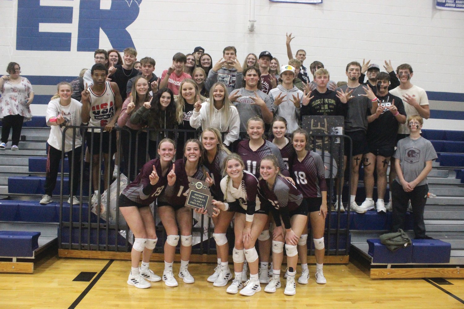 The Mountain Grove Lady Panthers' volleyball team celebrates with some fans after the big district title victory.